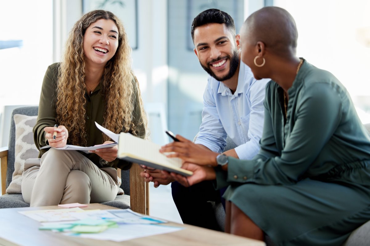 AdobeStock_526212858_Happy business people smile during a planning meeting 1200x800